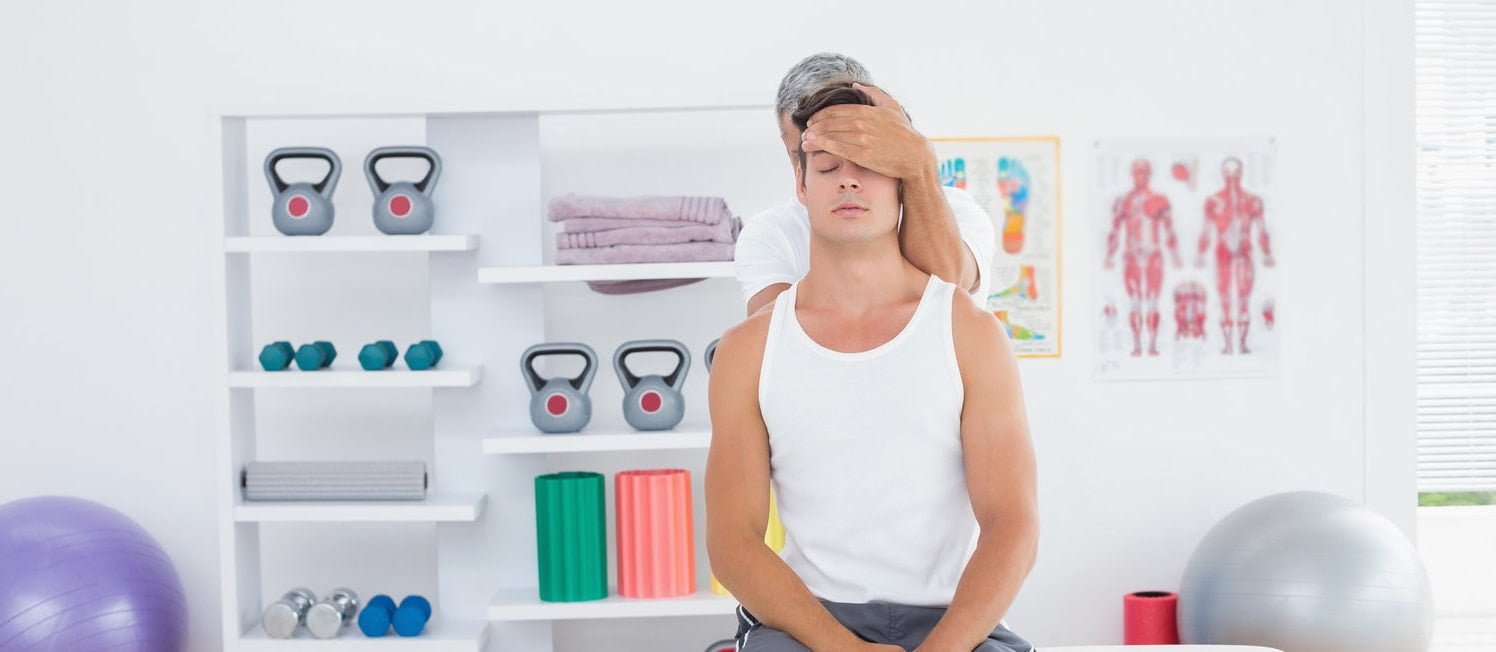 Chiropractor adjusts patient in Manhattan clinic with therapy equipment