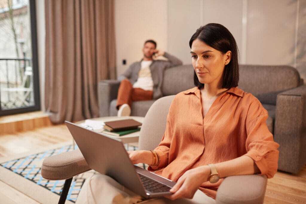 Woman working from home at a desk with laptop