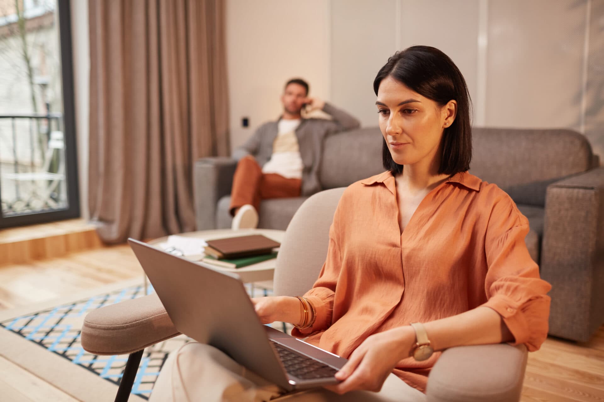 Woman working from home at a desk with laptop