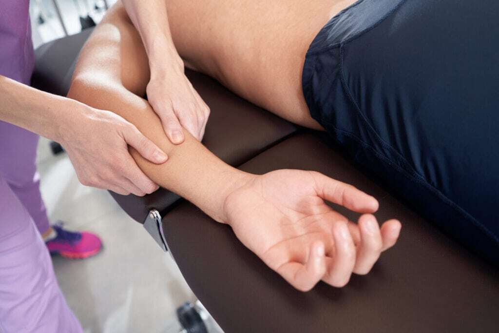 Therapist providing hand massage during physical therapy