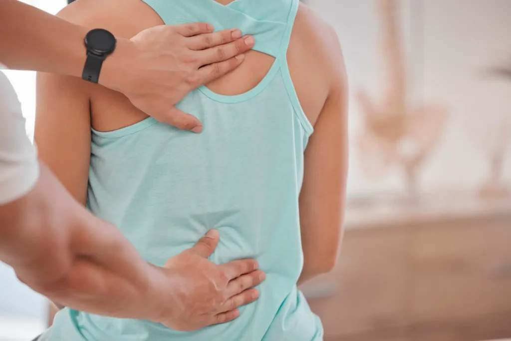 Chiropractor in Manhattan, NYC performing spinal adjustment on patient in clinic