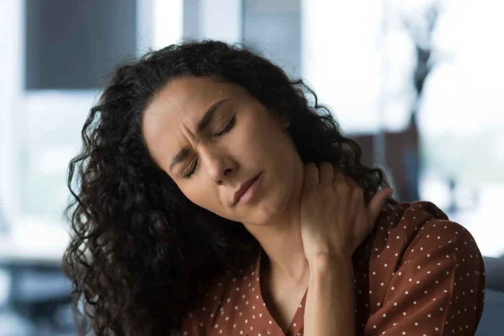 Woman with neck pain, seeking chiropractic care in Manhattan, NYC