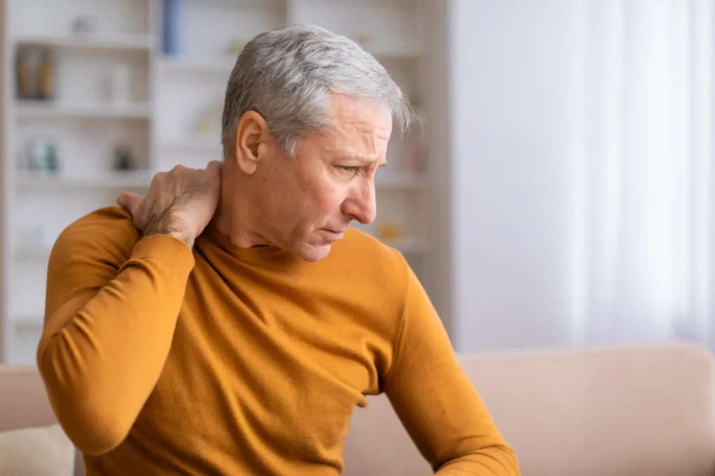Senior man with neck pain, potential chiropractic patient in Manhattan, NYC