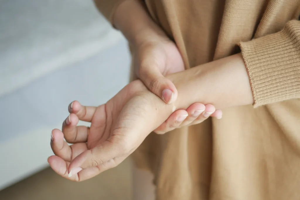 Hand holding wrist, indicating pain relief treatment at a Manhattan chiropractic and physical therapy clinic