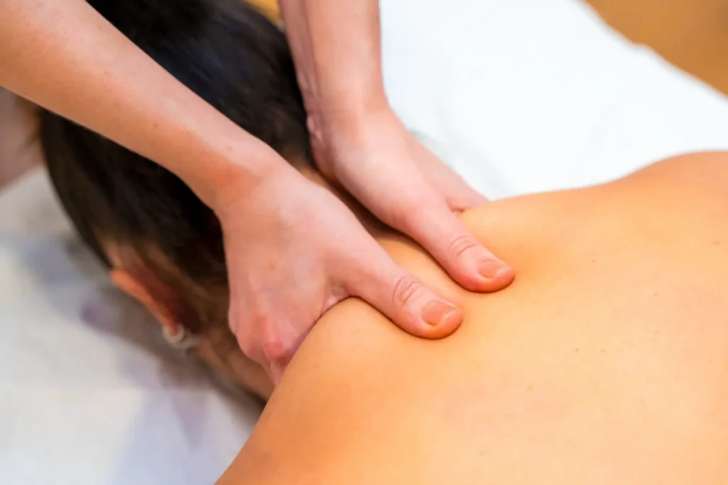 Chiropractor performing neck massage therapy in Manhattan, NYC clinic