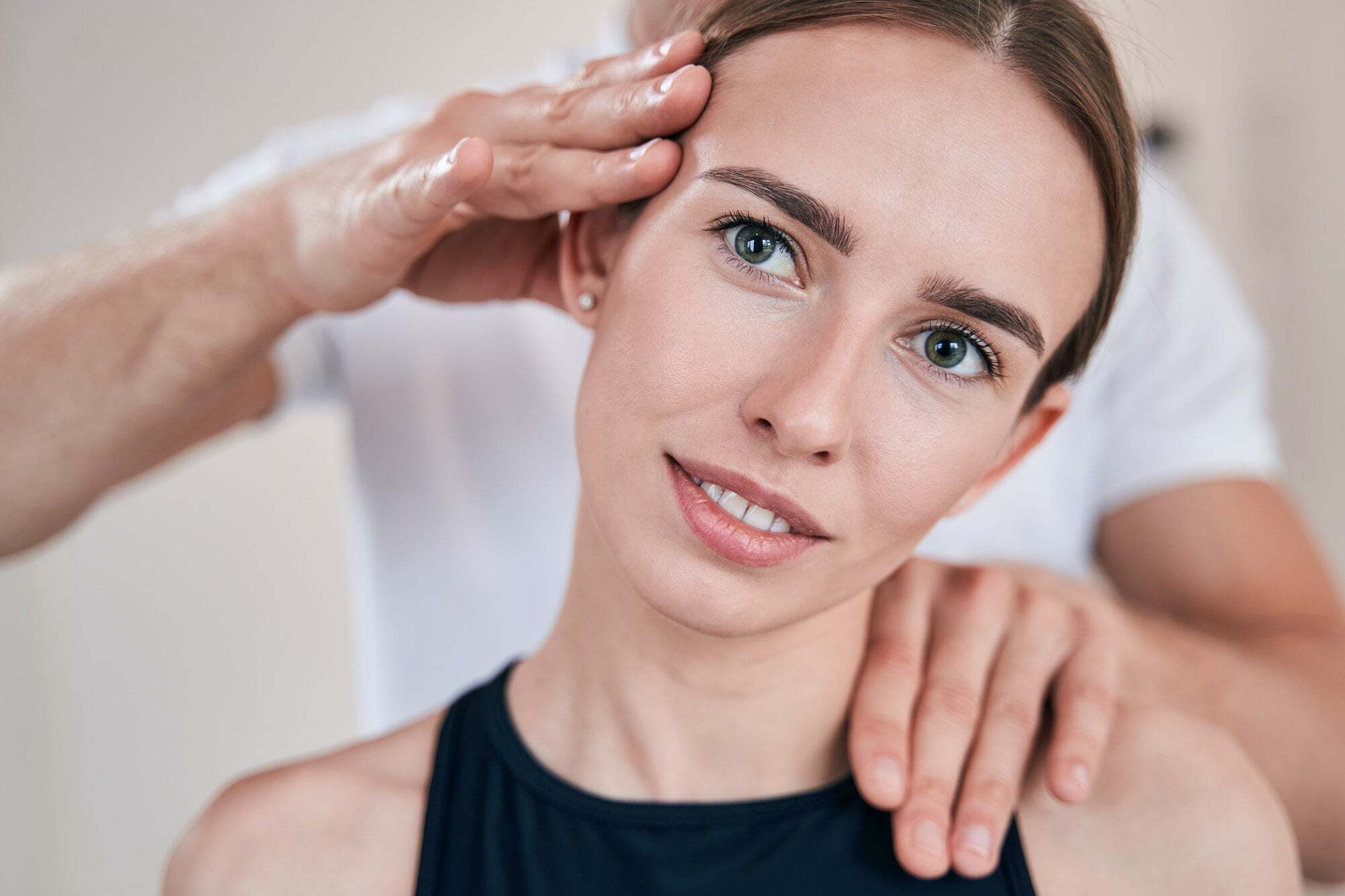 Chiropractor adjusting patient's neck in a Manhattan clinic, NYC