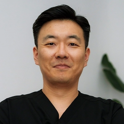 Portrait of Dr. Youngil Jang, PT, DPT — male physical therapist at Prestige Health & Wellness PT in New York City, wearing professional attire and smiling against a neutral background.