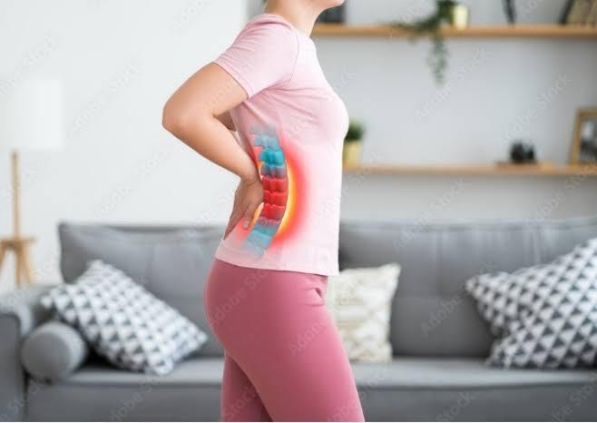 Person with back pain illustration, highlighting spine issues, ideal for Manhattan chiropractic and physical therapy..