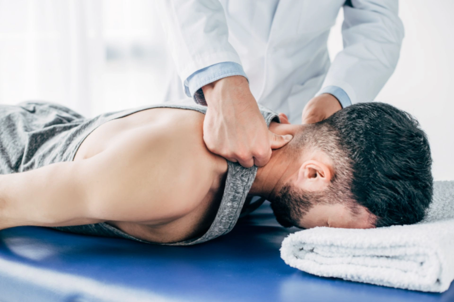 Chiropractor performing neck adjustment on patient at Manhattan clinic
