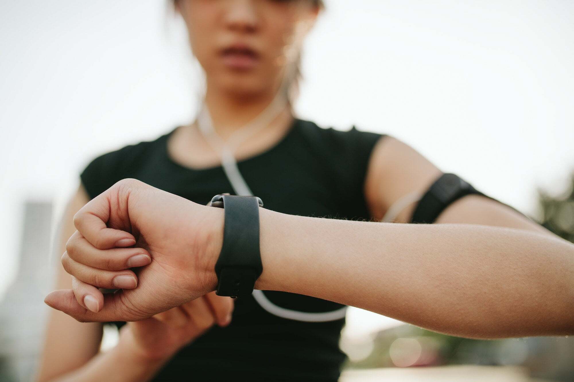 Woman checking smartwatch during sports performance training