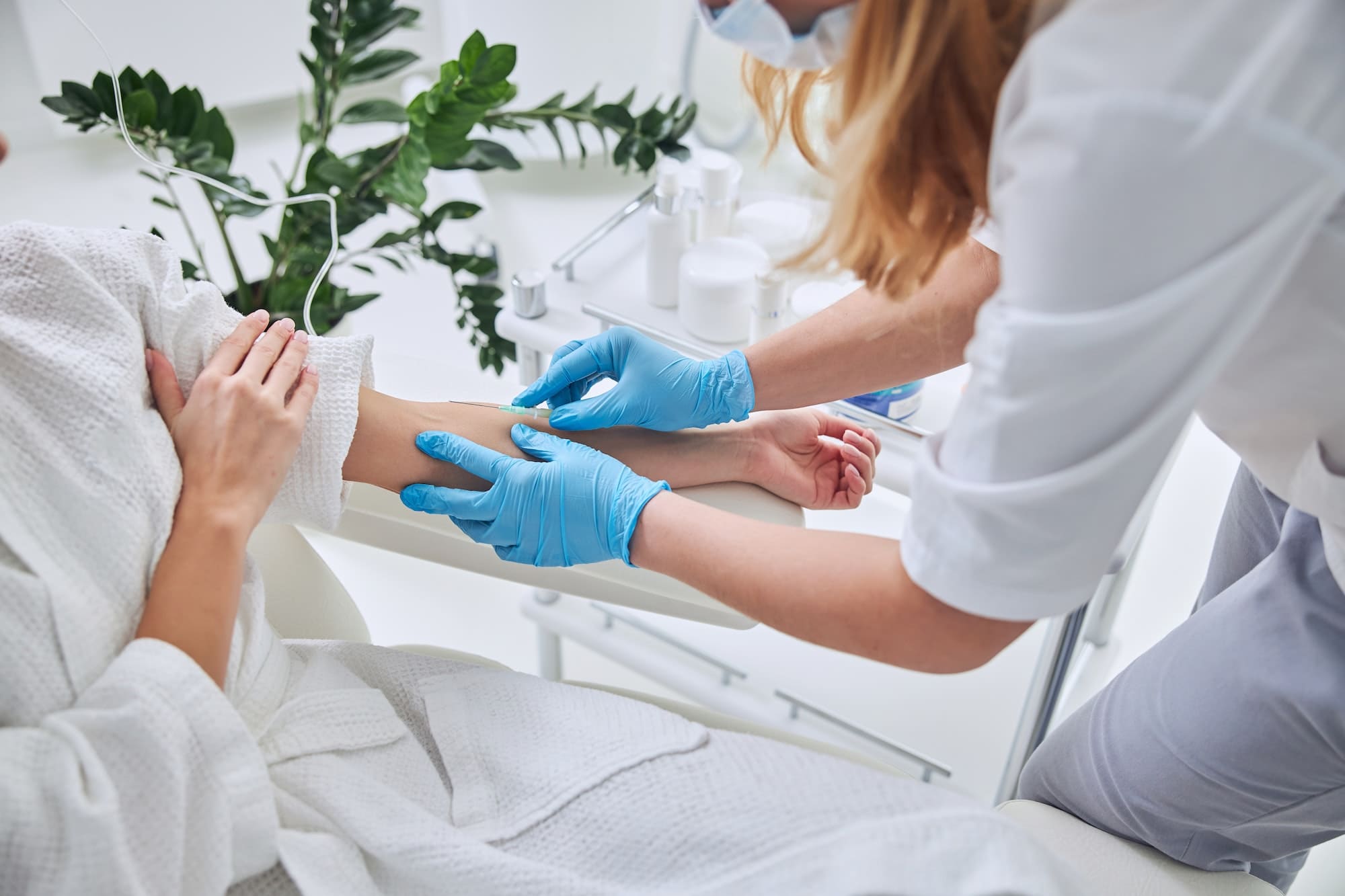 Healthcare professional preparing IV therapy in a wellness clinic