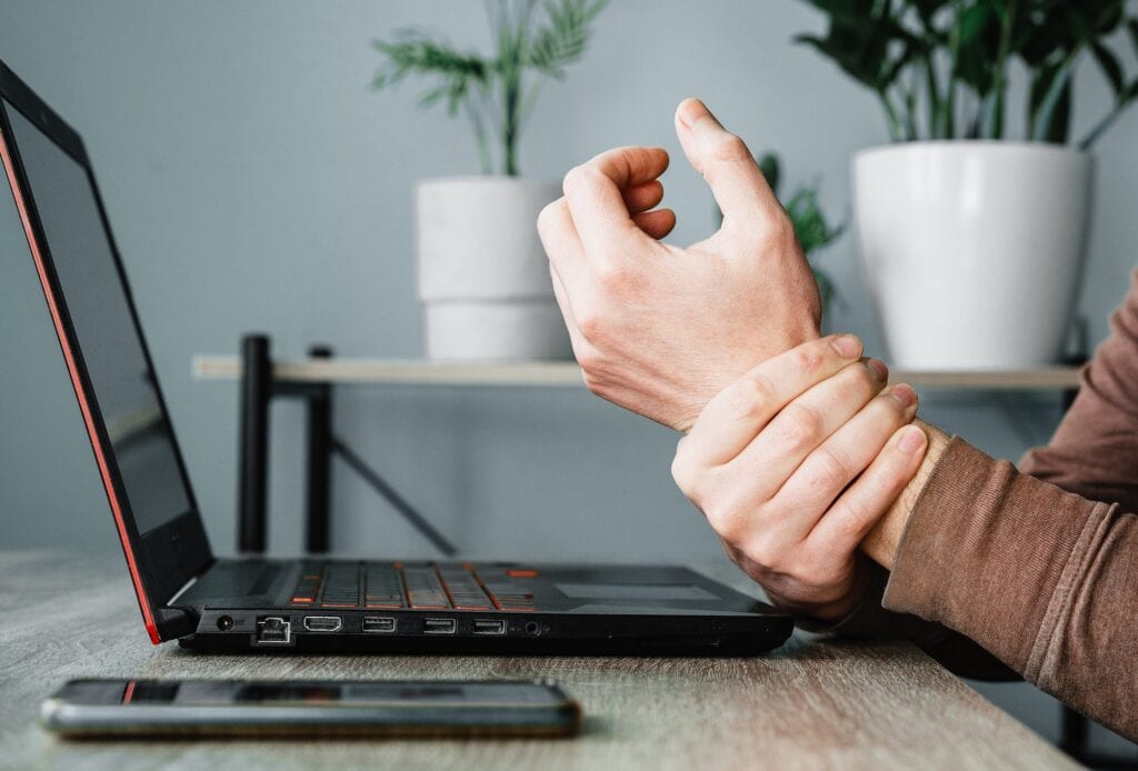 A man suffering from sore wrist or arthritis, occupational disease