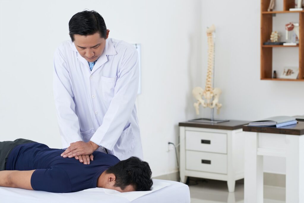 Chiropractor adjusting spine