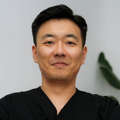 Portrait of Dr. Youngil Jang, PT, DPT — male physical therapist at Prestige Health & Wellness PT in New York City, wearing professional attire and smiling against a neutral background.