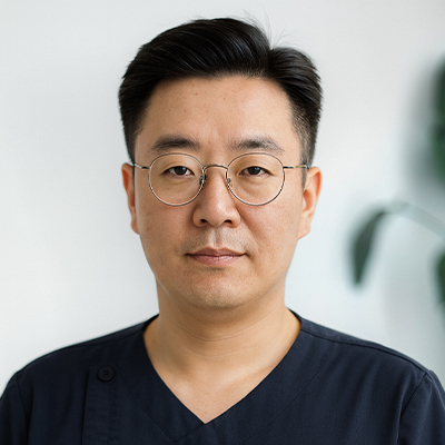 Portrait of Dr. Youngil Jang, PT, DPT — male physical therapist at Prestige Health & Wellness PT in New York City, wearing professional attire and smiling against a neutral background.